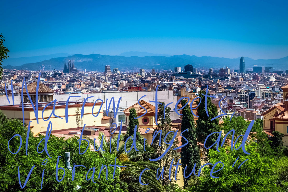 View over the sunlit Barcelona skyline, with La Sagrada Familia and the Glòries Tower poking out above the characteristically European flat cityscape. Graffiti overlay featuring a quote from the article: "Narrow streets, old buildings and vibrant culture"