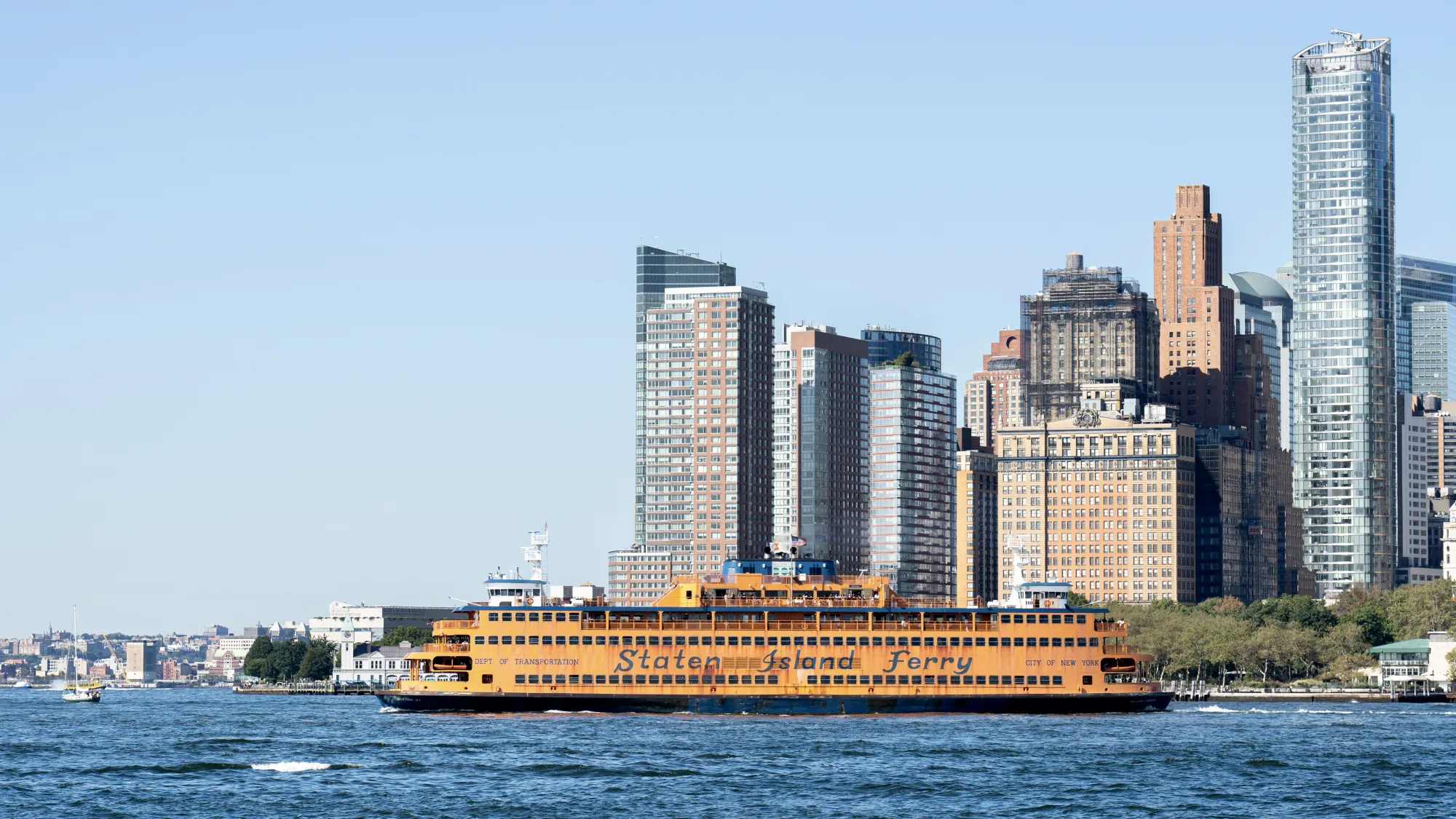 The Staten Island Ferry on the water. Some of Manhattan's buildings can be seen behind it