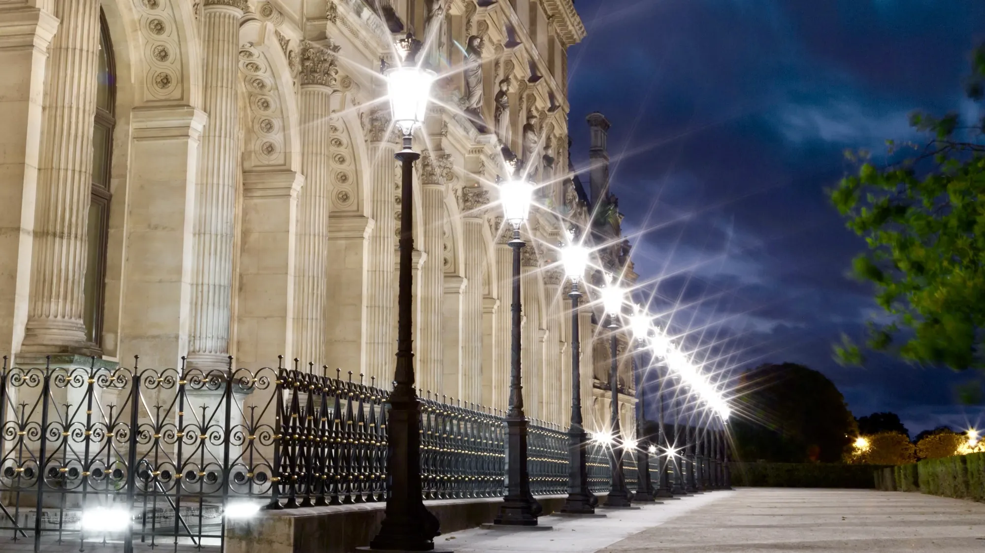 Street lights against a dusky sky in Paris, near the Louvre