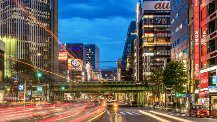 View of a Tokyo street, in low shutter speed to exaggerate the stream of car tail-lights heading into the distance. The photo looks toward the Ginza area of Tokyo.